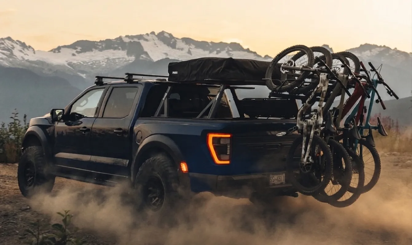 A couple loading bikes onto a hitch-mounted bike rack